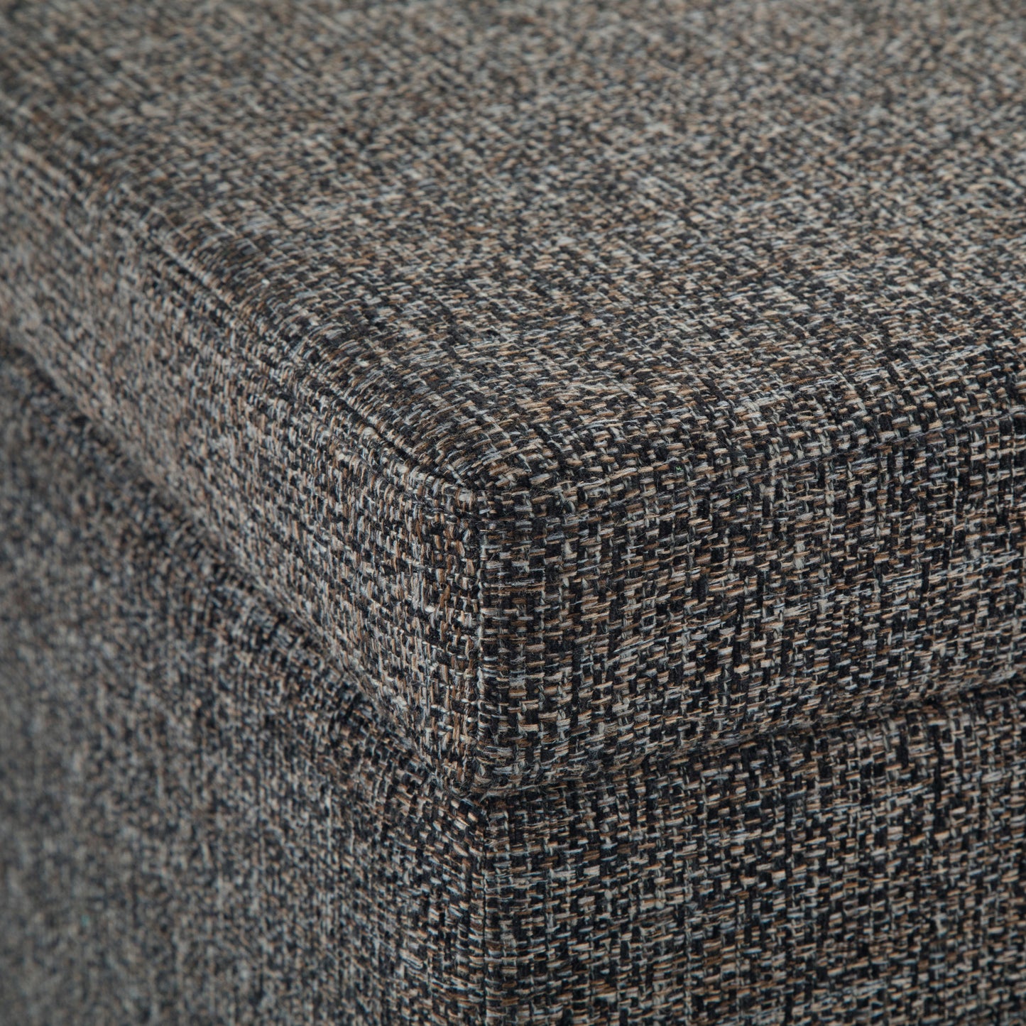 Close-up of the corner of the Avalon Storage Ottoman Bench in dark gray, featuring textured, speckled fabric and detailed weave on the upholstered surface.