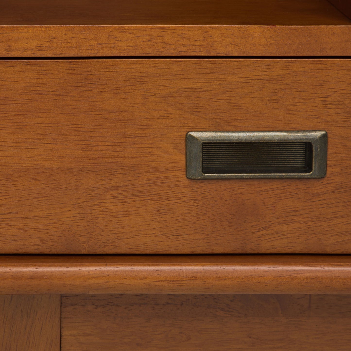 Close-up of the Draper - Mid Century Wide Bookcase And Storage Unit, highlighting its warm brown wood grain, metal label holder, and timeless, classic design.