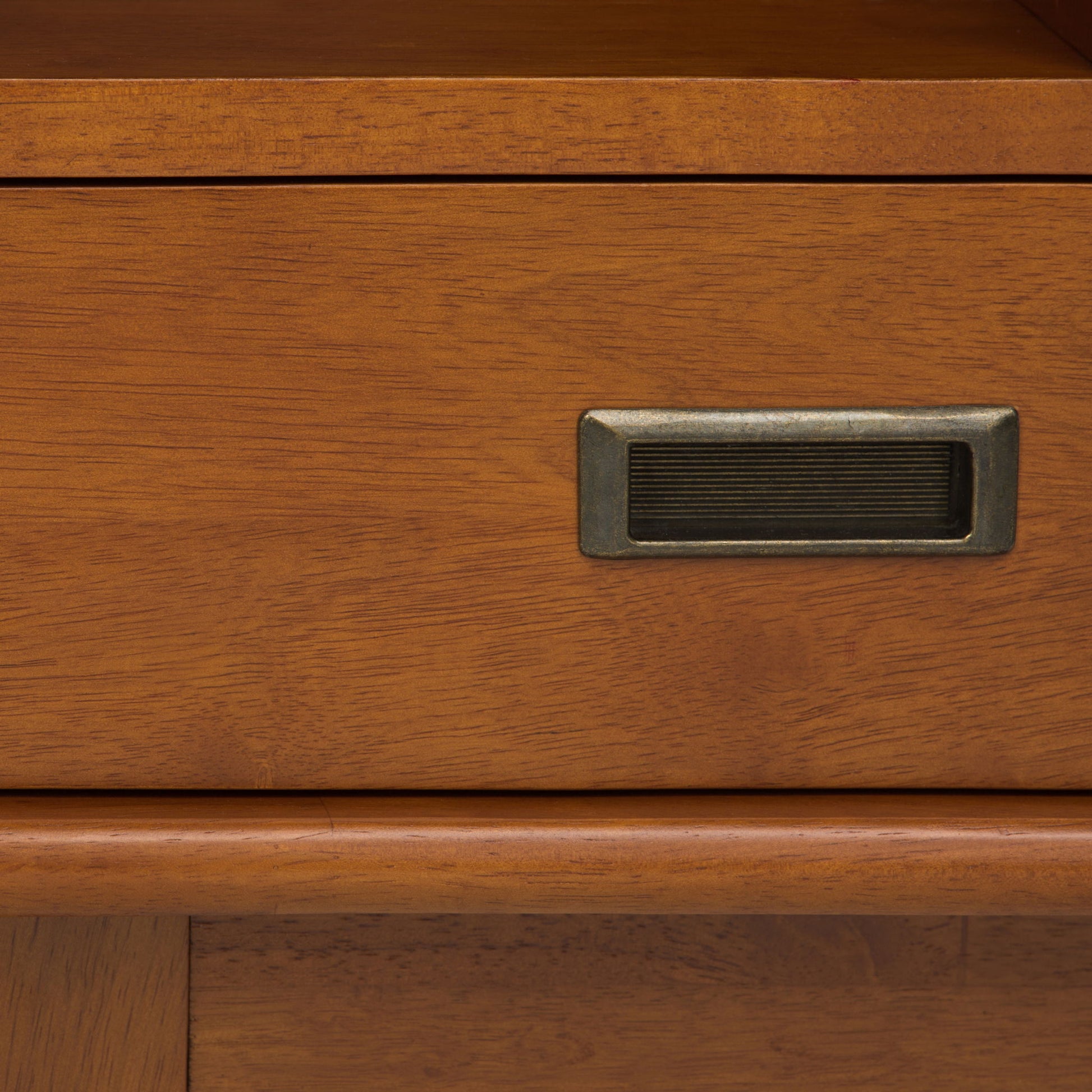 Close-up of the Draper - Mid Century Wide Bookcase And Storage Unit, highlighting its warm brown wood grain, metal label holder, and timeless, classic design.