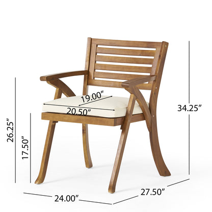 The Outdoor Hermosa 5 Piece Wood Dining Set With Cushions in Teak/Beige includes a wooden armchair with a white cushioned seat, slatted backrest, and curved legs. Dimensions for seat and overall height, width, and depth are shown around the chair.
