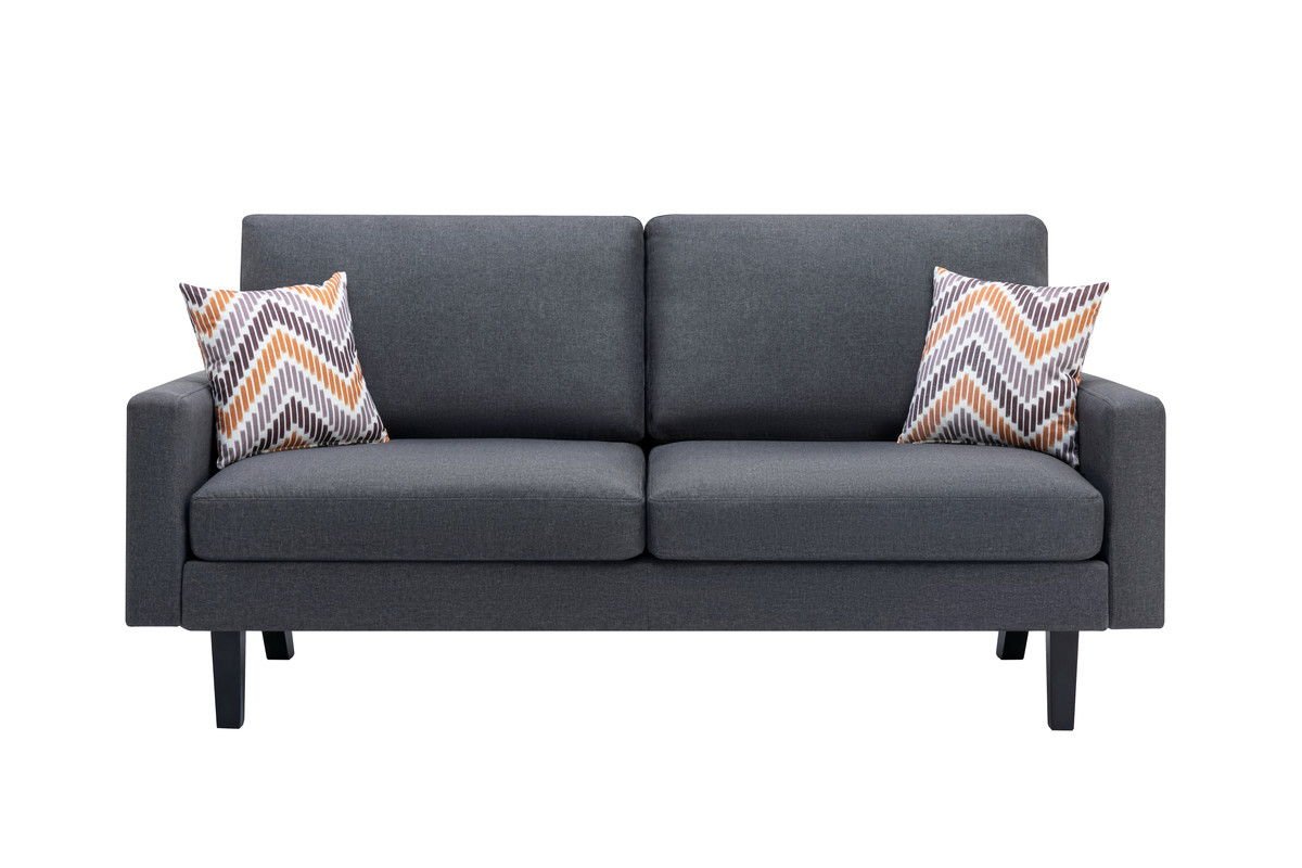 The Bahamas Minimalistic Sofa features a modern dark gray design with straight arms and wooden legs, accented by two orange, gray, and white chevron throw pillows. Shown against a white background.