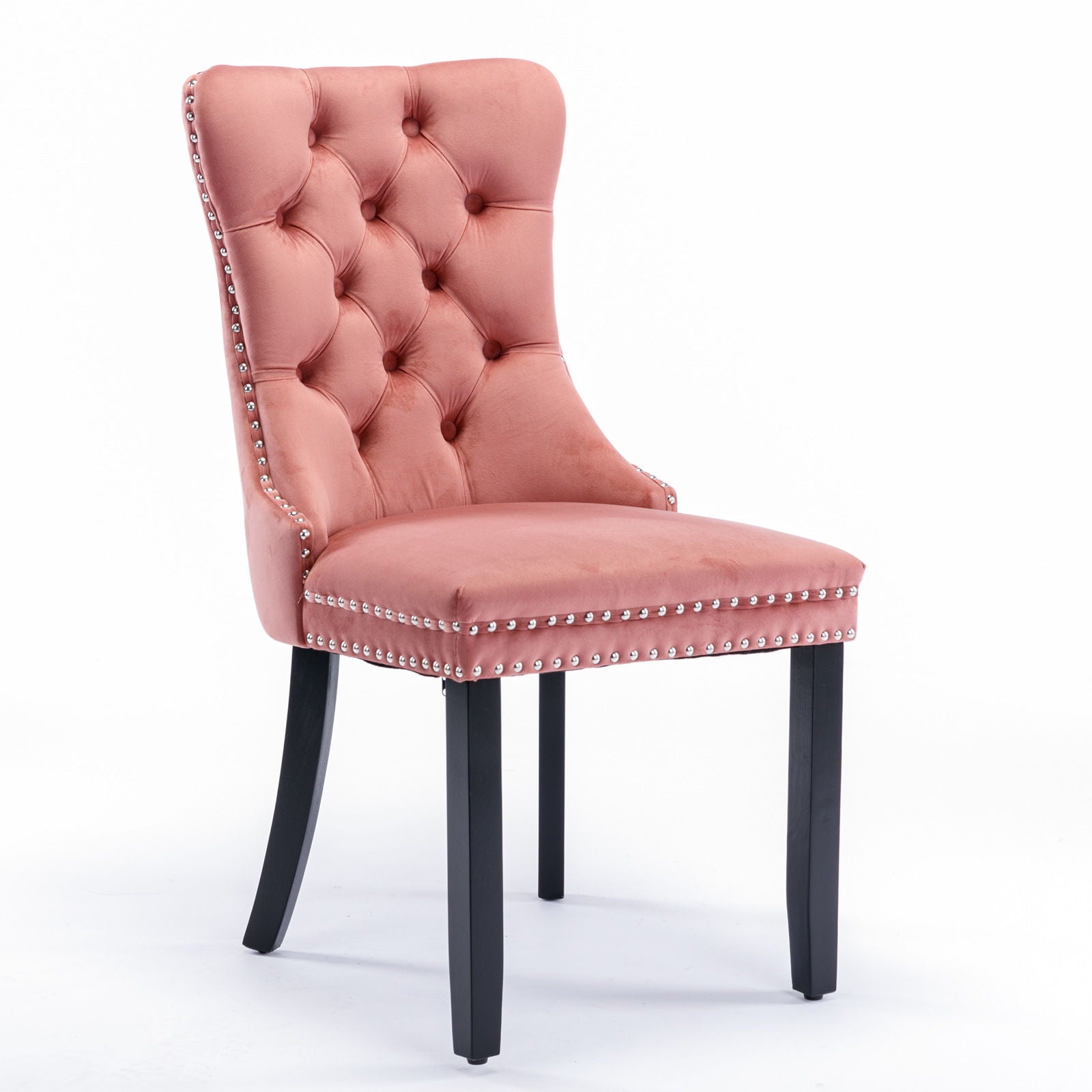 The Nikki set features modern, high-end velvet upholstered dining chairs with tufted backrests, solid wood legs, and silver nailhead trim, shown here in pink against a plain white background.