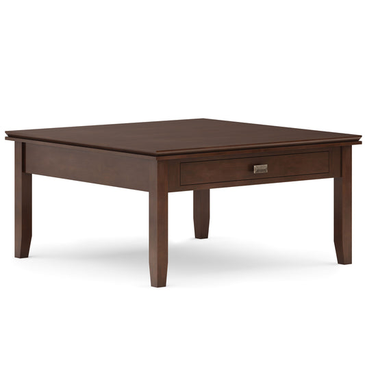 The Artisan Square Coffee Table in russet brown features tapered legs, a single front drawer with a metal handle, and a simple modern design.