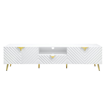 The Gaines - High Gloss TV Stand in white features diagonal textured patterns, gold-accented handles, gold metal legs, two cabinets, one drawer, and an open central shelf with a circular cable management hole.