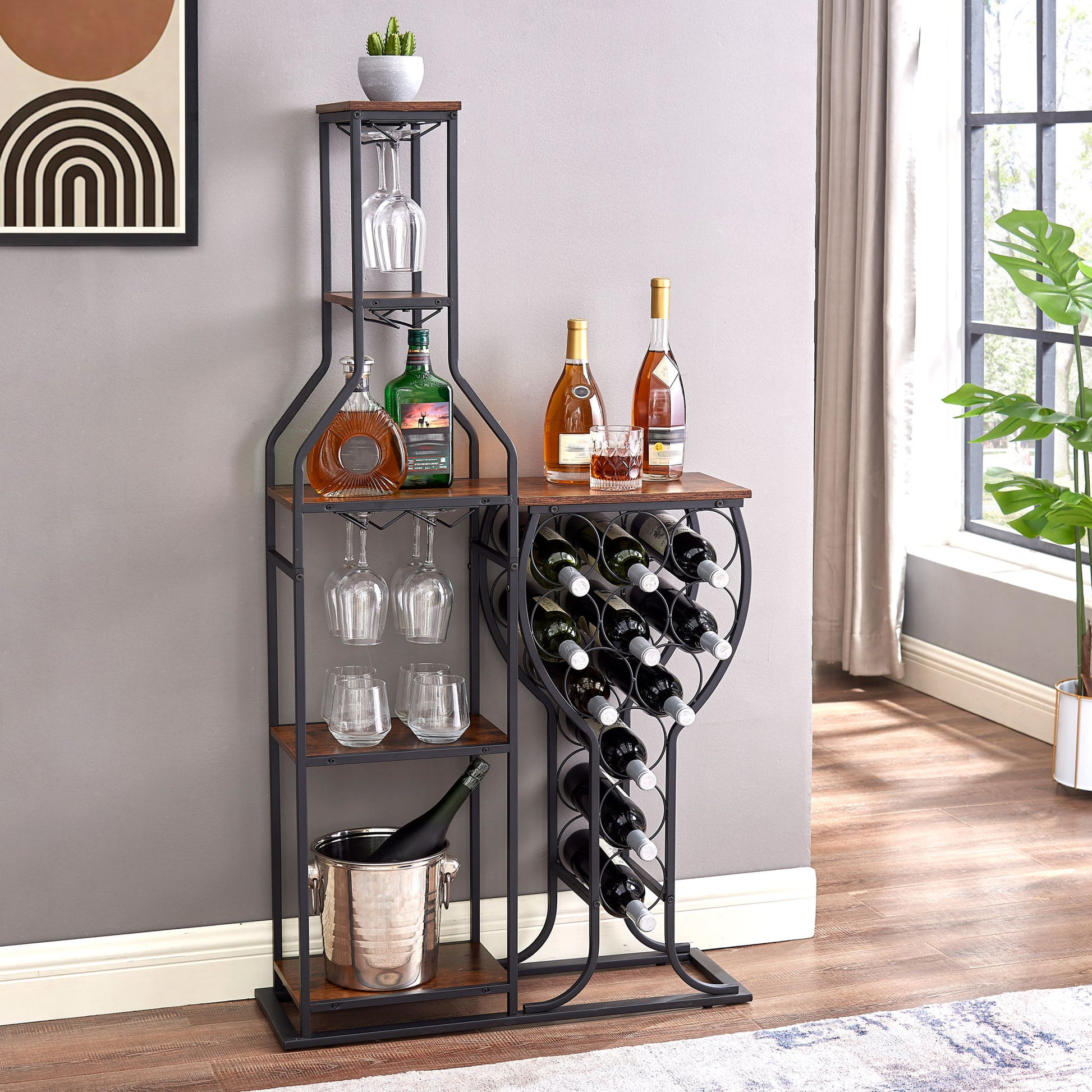 The 11 Bottle Wine Bakers Rack features five tiers, wine glass holders, and storage shelves for bottles and liquor. An ice bucket sits below, sunlight streams through the window, and geometric art hangs above on the gray wall.