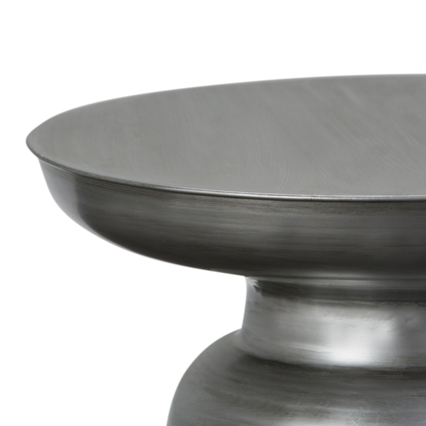 Close-up of the upper section of the Toby - Handcrafted Metal Accent Table, featuring a wide, flat top and a rounded, tapered base with a brushed steel finish.
