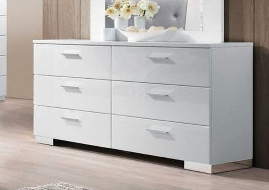 The Lorimar - Dresser - White features six drawers and stands on a light wooden floor. Topped with a large mirror, a vase of white flowers, and decor, it’s set against a light-colored wall for a modern look.
