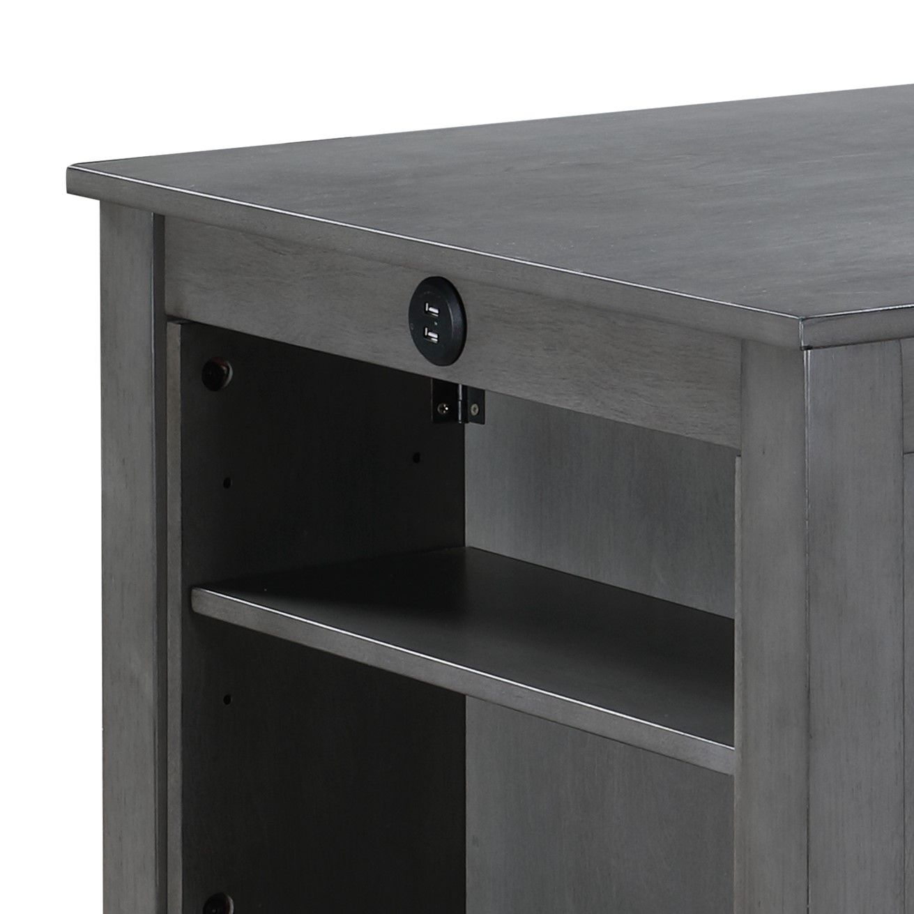 Close-up of the Graham dining table in gray wood, highlighting an open shelf and front-facing round power outlet with USB ports. This compact piece features a smooth surface and a solid, simple design.