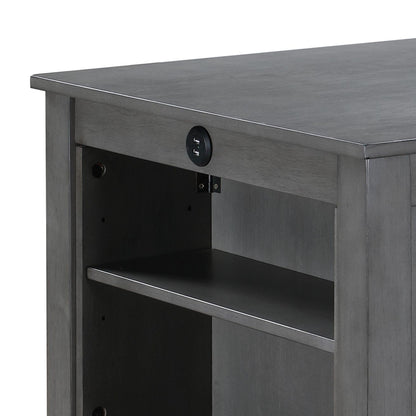 Close-up of the Graham dining table in gray wood, highlighting an open shelf and front-facing round power outlet with USB ports. This compact piece features a smooth surface and a solid, simple design.