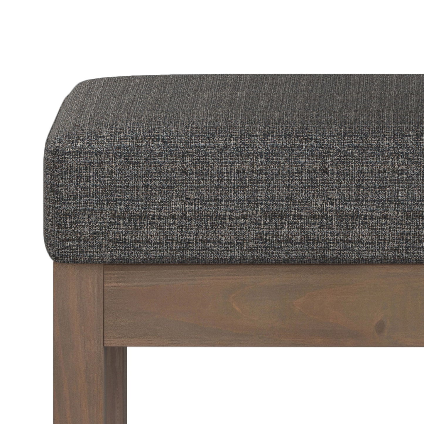 Close-up of the Milltown Upholstered Ottoman Bench, highlighting its dark gray cushion and wooden frame with visible fabric texture and wood grain.