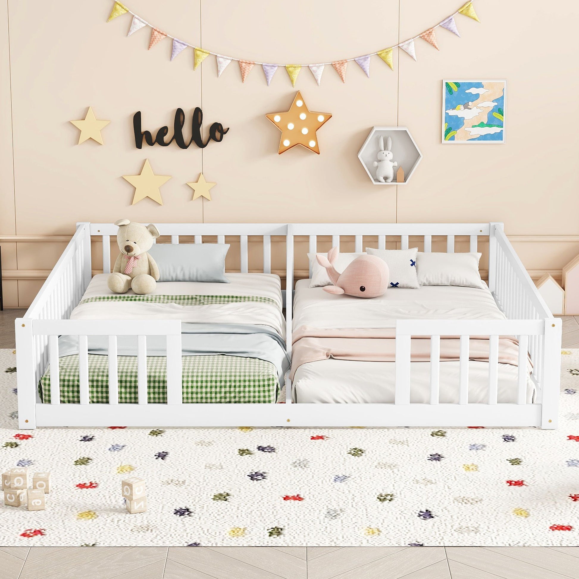 A children's bedroom features a Double Floor Bed With Fence and guardrails (no door), placed side by side with green checkered and pink bedding, plush toys, and a wall decorated with stars, "hello" sign, and bunting.