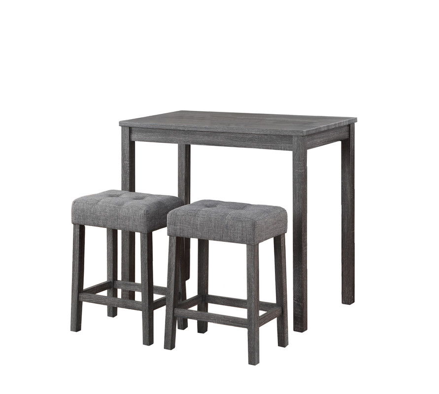 The Lux 3 Piece Counter Height Pub Table set includes a small rectangular wooden table with a dark gray finish and two matching tufted linen upholstered stools with cushioned seats.