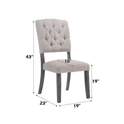 The Bernard - Weathered Side Chair (Set of 2) features light gray upholstery, a button-tufted backrest, and dark wooden legs. Dimensions: 43"H x 18"W seat x 19" seat height x 23"D x 19" between front legs.