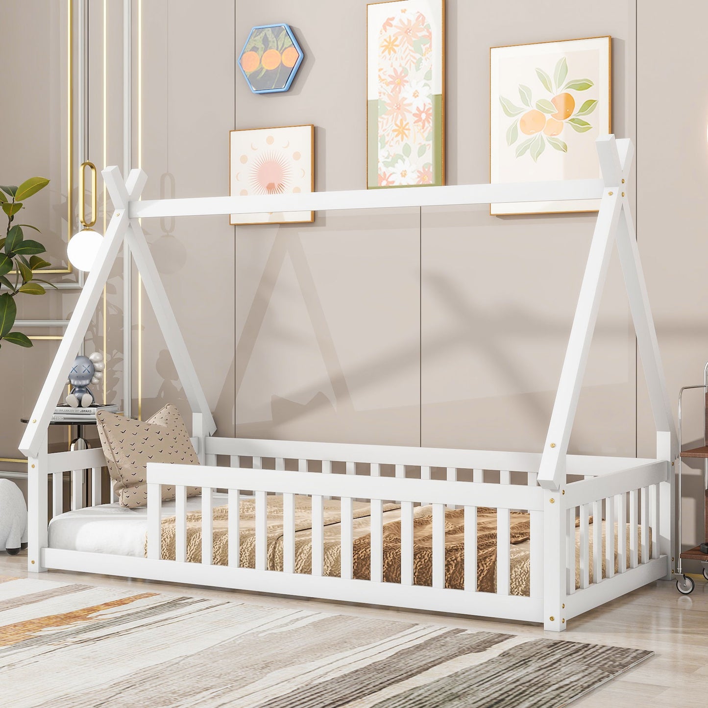 A Tent-Shaped Floor Bed, teepee bed with guardrails and slats, is featured in a modern room with neutral walls, patterned artwork, and decorative pillows and rugs.