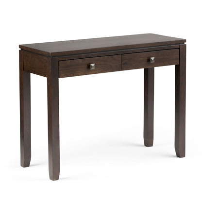 The Cosmopolitan - Multipurpose Table is a dark wood rectangular table with two drawers featuring square metal knobs and four straight legs, shown against a white background.