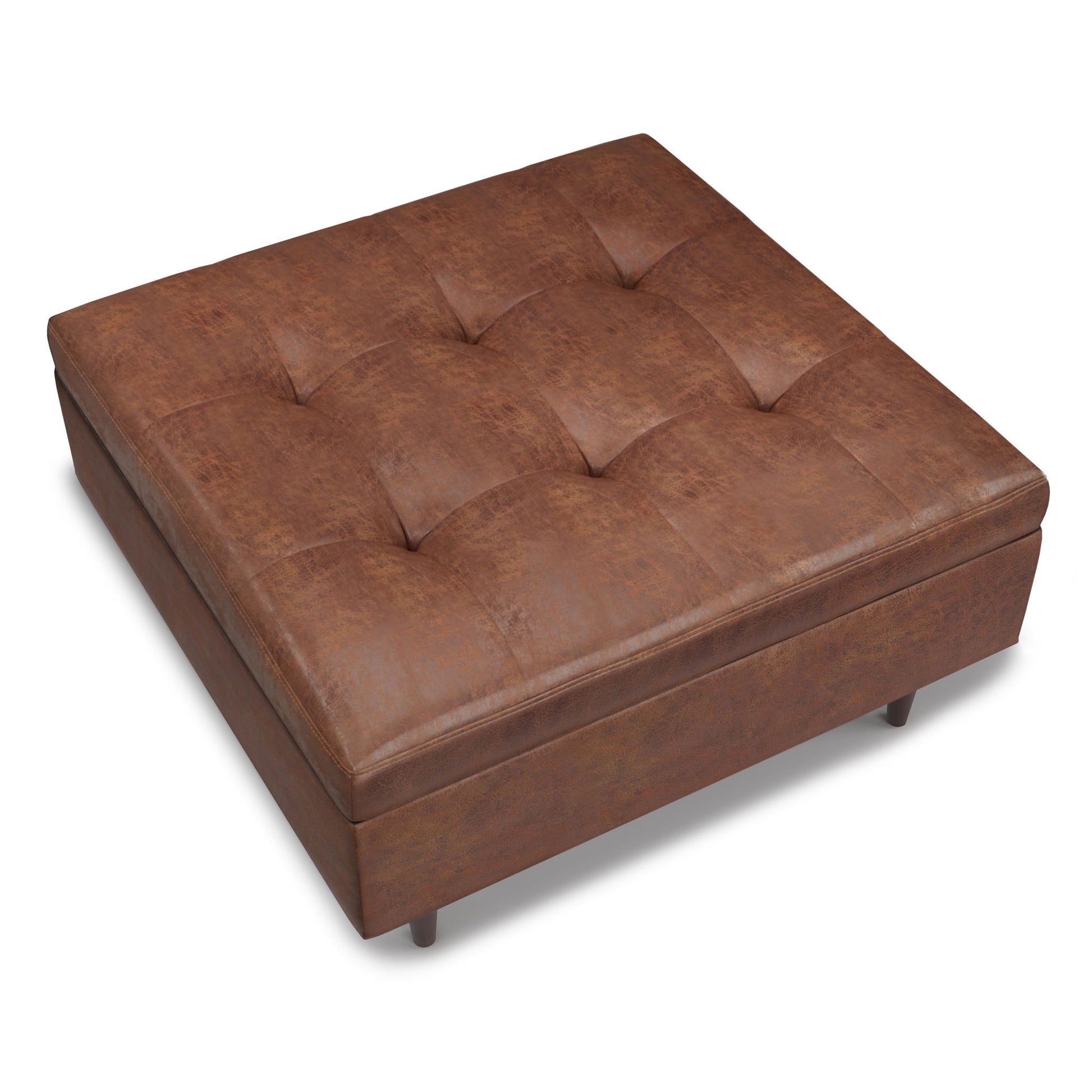 The Shay Large Square Coffee Table Storage Ottoman features a brown leather, tufted cushion top, short round legs, soft textured look, and modern mid-century design.