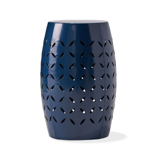 The 12" Outdoor Lace Cut Side Table features a glossy navy blue ceramic barrel shape with petal-shaped cutout details.