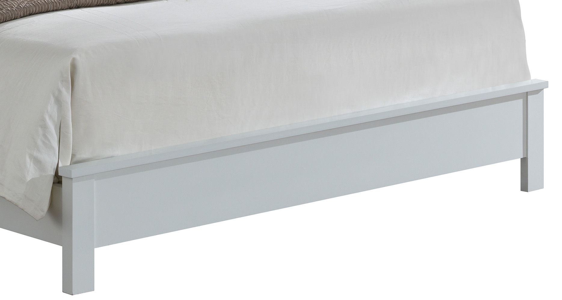 A close-up of the footboard of the Transitional Modern Design Bed, a white wooden frame topped with a light-colored blanket and comforter.
