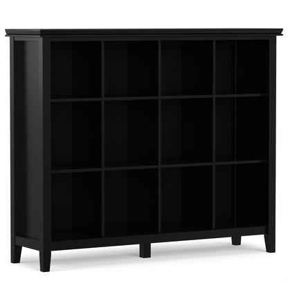 The Artisan - Cube Storage is a black wooden bookshelf with 12 square open compartments and four legs. Featuring a simple, modern design, it stands empty against a white background.