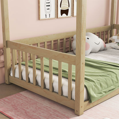 The Canopy Frame Floor Bed With Fence, Guardrails sits on a pink rug in a softly decorated room with animal-themed wall art, paired with a green blanket and an elephant-shaped pillow for a cozy toddler setup.