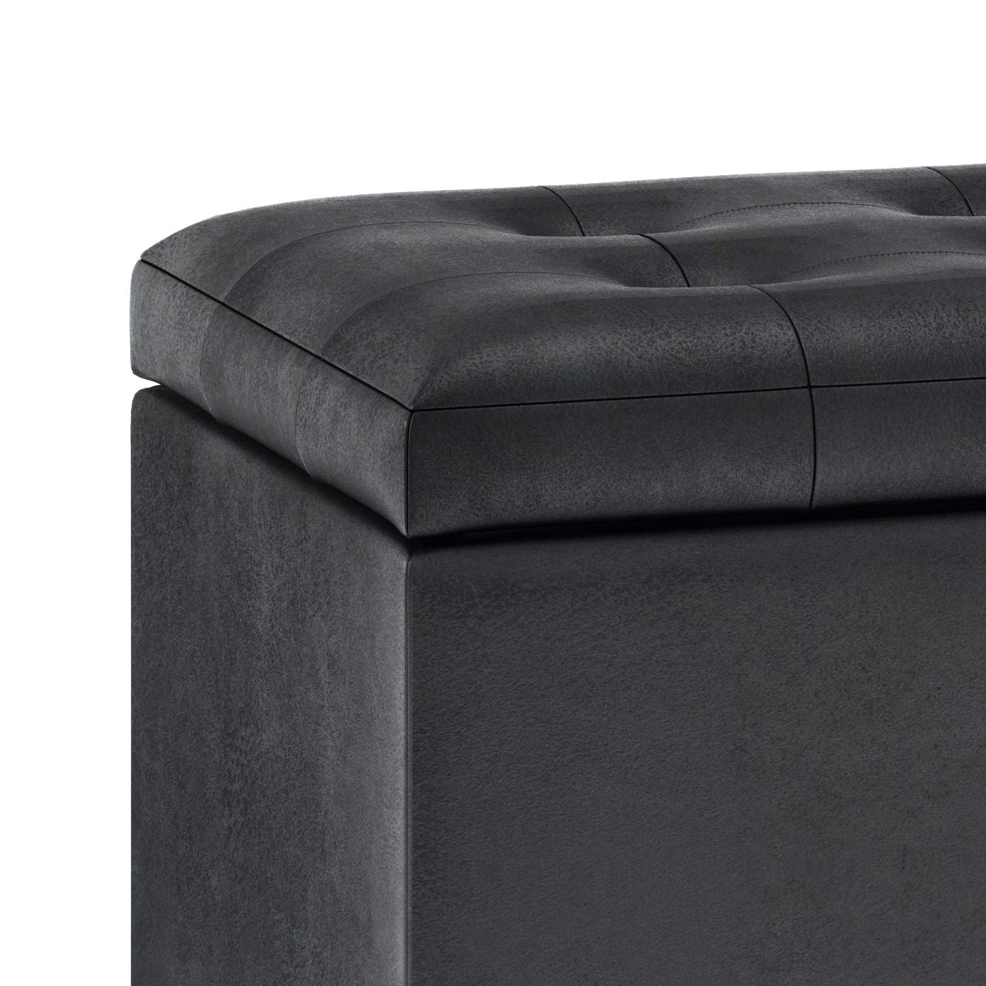 Close-up of the Cosmopolitan Upholstered Storage Ottoman in dark gray faux leather with a tufted, cushioned lid and smooth finish, set against a white background.