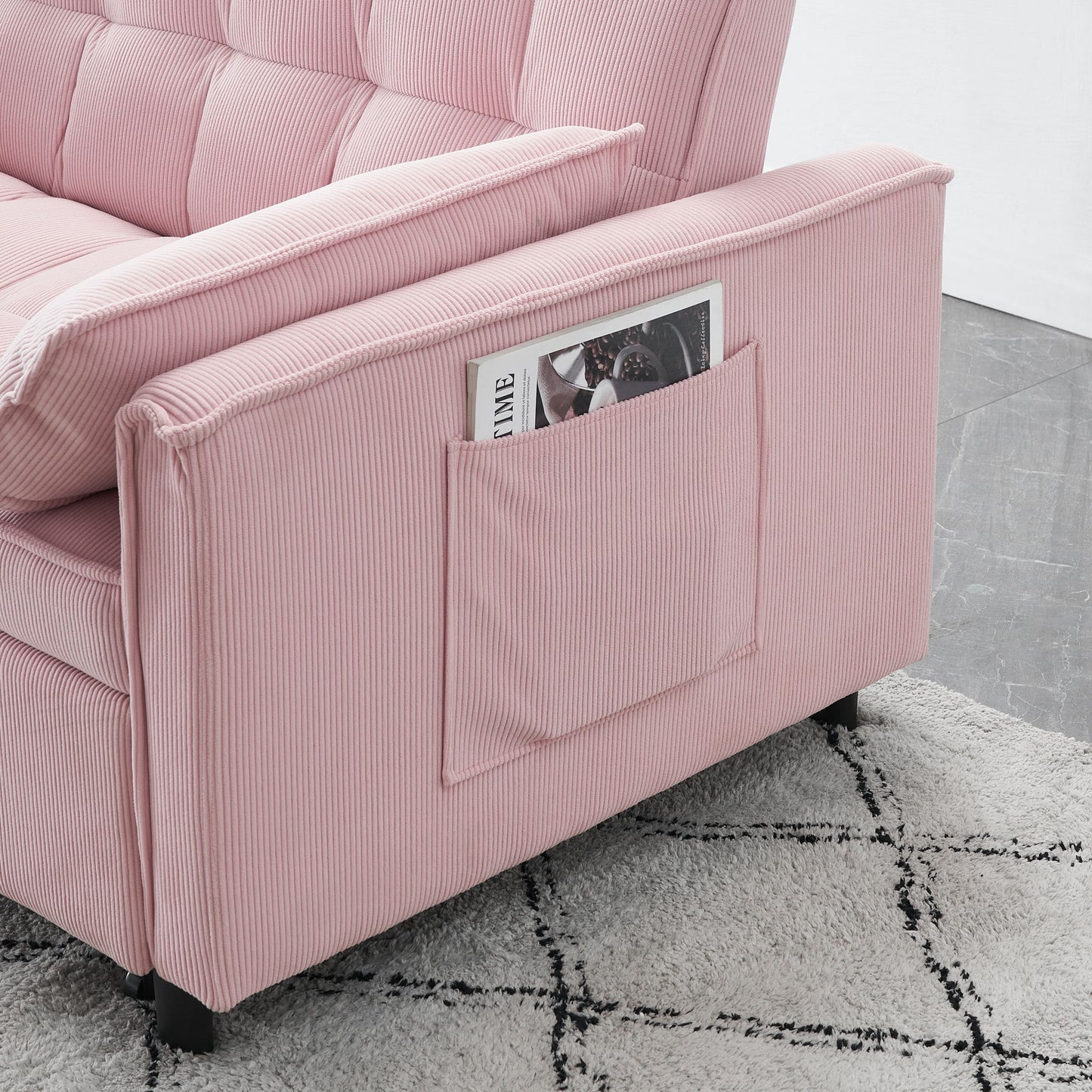 A Folding Sofa Bed With Adjustable Back Access To Sofa Recliner Single Bed sits on a light-patterned rug and gray tiled floor, featuring a side pocket on the armrest that holds a magazine.