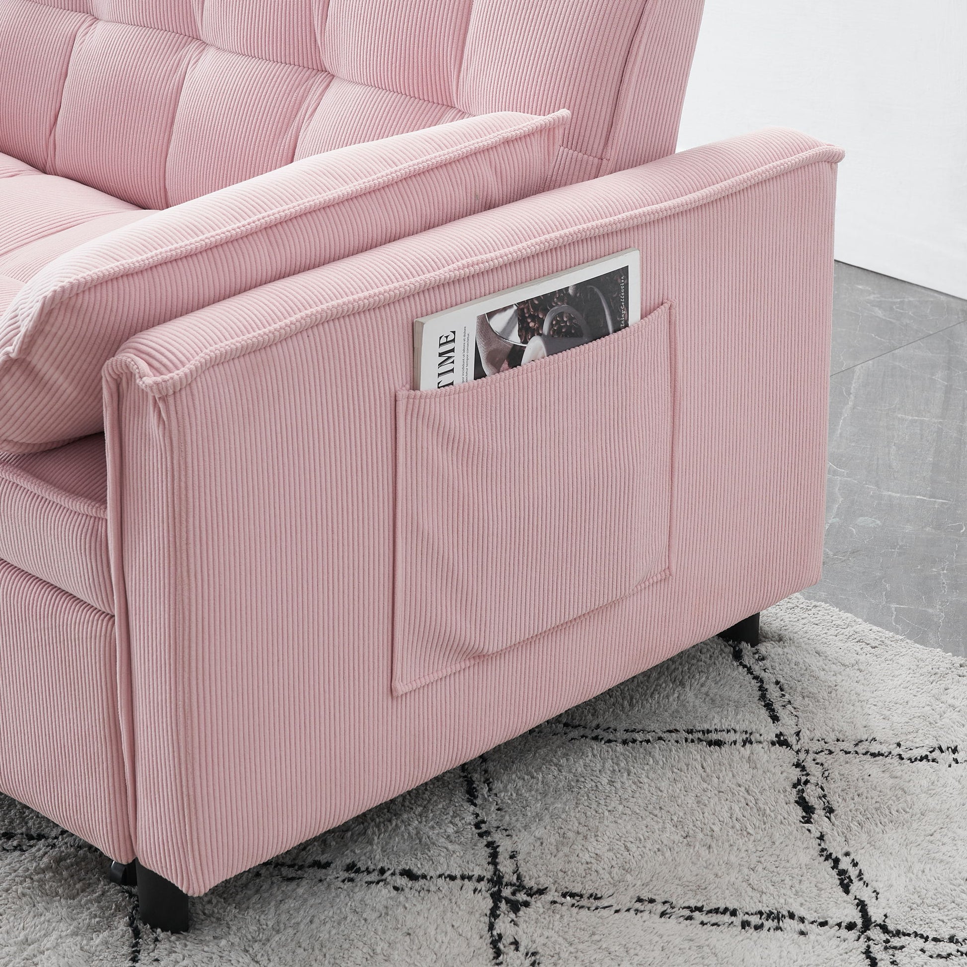 A Folding Sofa Bed With Adjustable Back Access To Sofa Recliner Single Bed sits on a light-patterned rug and gray tiled floor, featuring a side pocket on the armrest that holds a magazine.