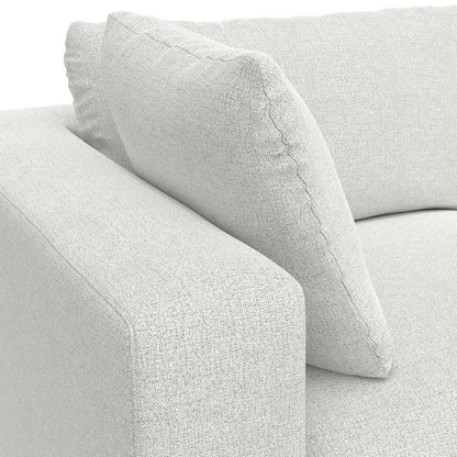 Close-up of the Jasmine - Handcrafted Sofa and Ottoman in light gray, featuring a thick armrest, backrest, and a plush square back cushion.