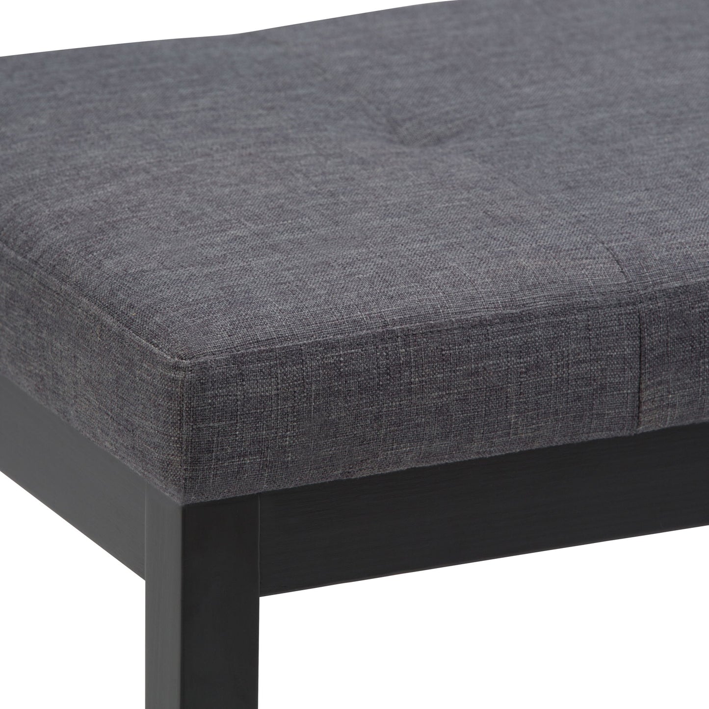 Close-up of the Lacey - Upholstered Tufted Ottoman Bench featuring a dark gray textured fabric seat with visible stitching and black wooden legs.