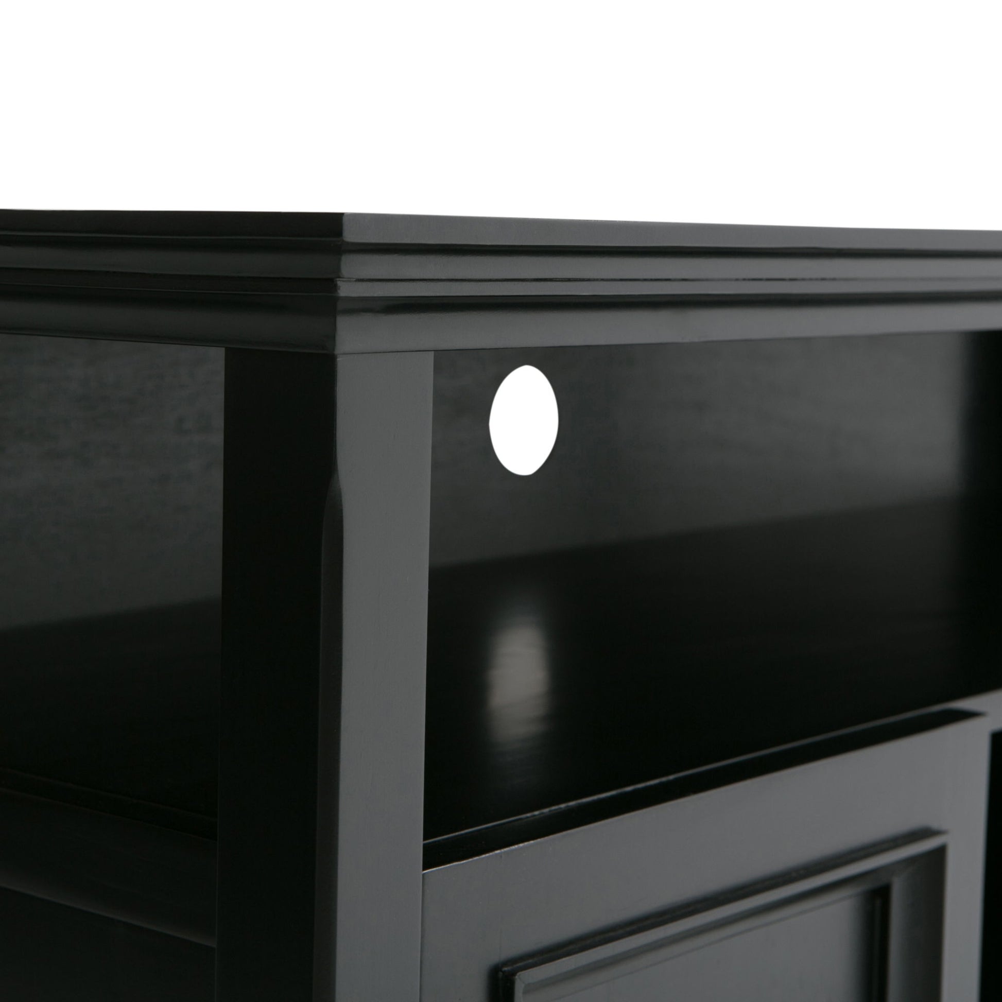 Close-up view of the Amherst - TV Media Stand, Handcrafted, in black wood with a shelf and a circular cable management hole at the back. The surface and edges are smooth with a glossy finish.