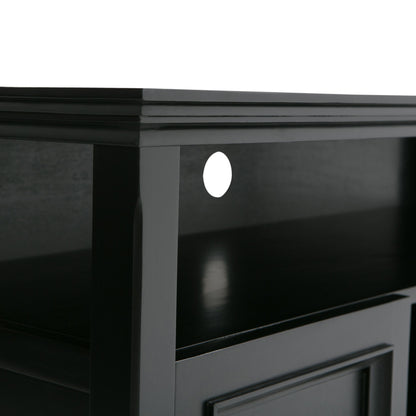 Close-up view of the Amherst - TV Media Stand, Handcrafted, in black wood with a shelf and a circular cable management hole at the back. The surface and edges are smooth with a glossy finish.