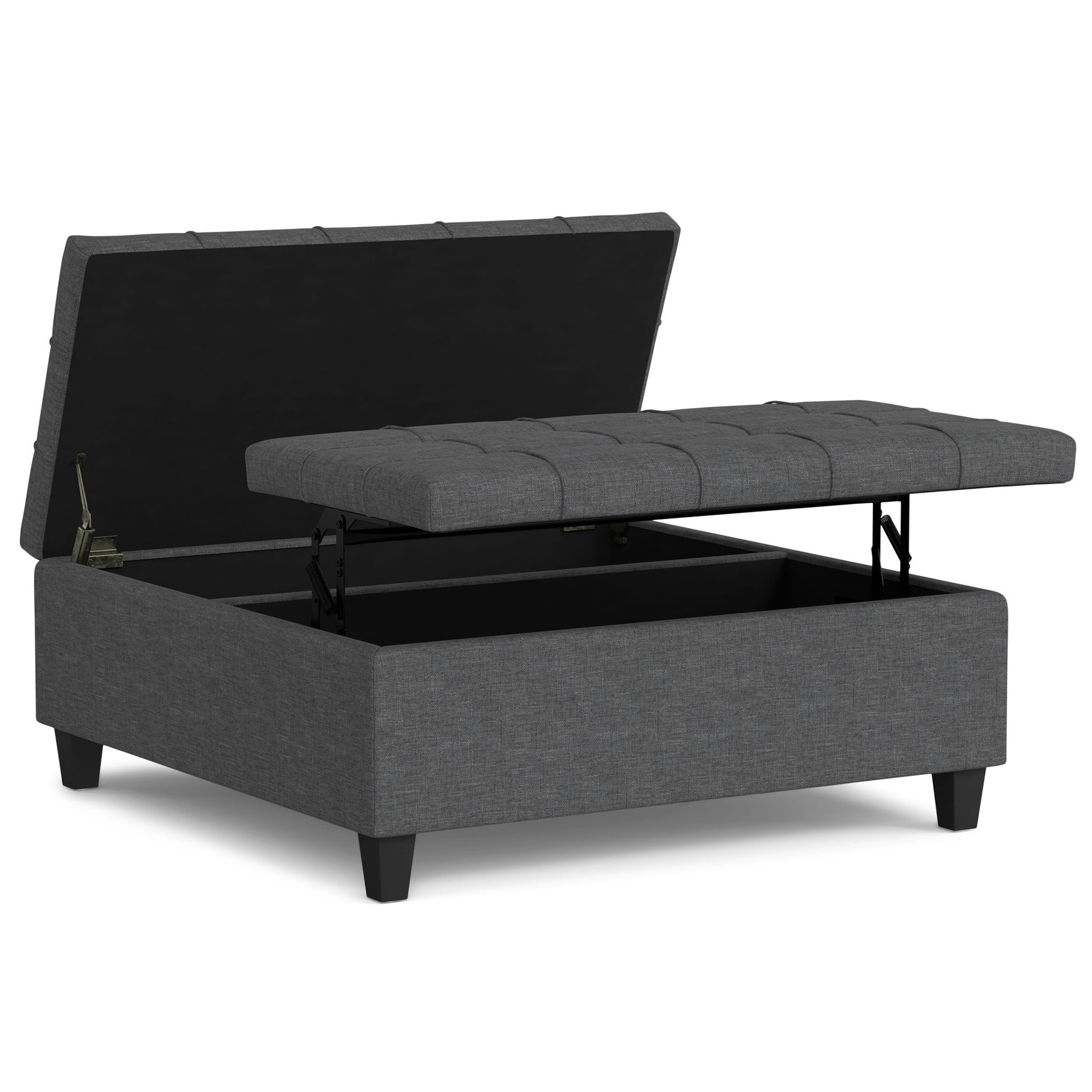 The Harrison Upholstered Coffee Table Storage Ottoman features a gray tufted lift-top lid with an open storage compartment inside, and stands on short black legs.