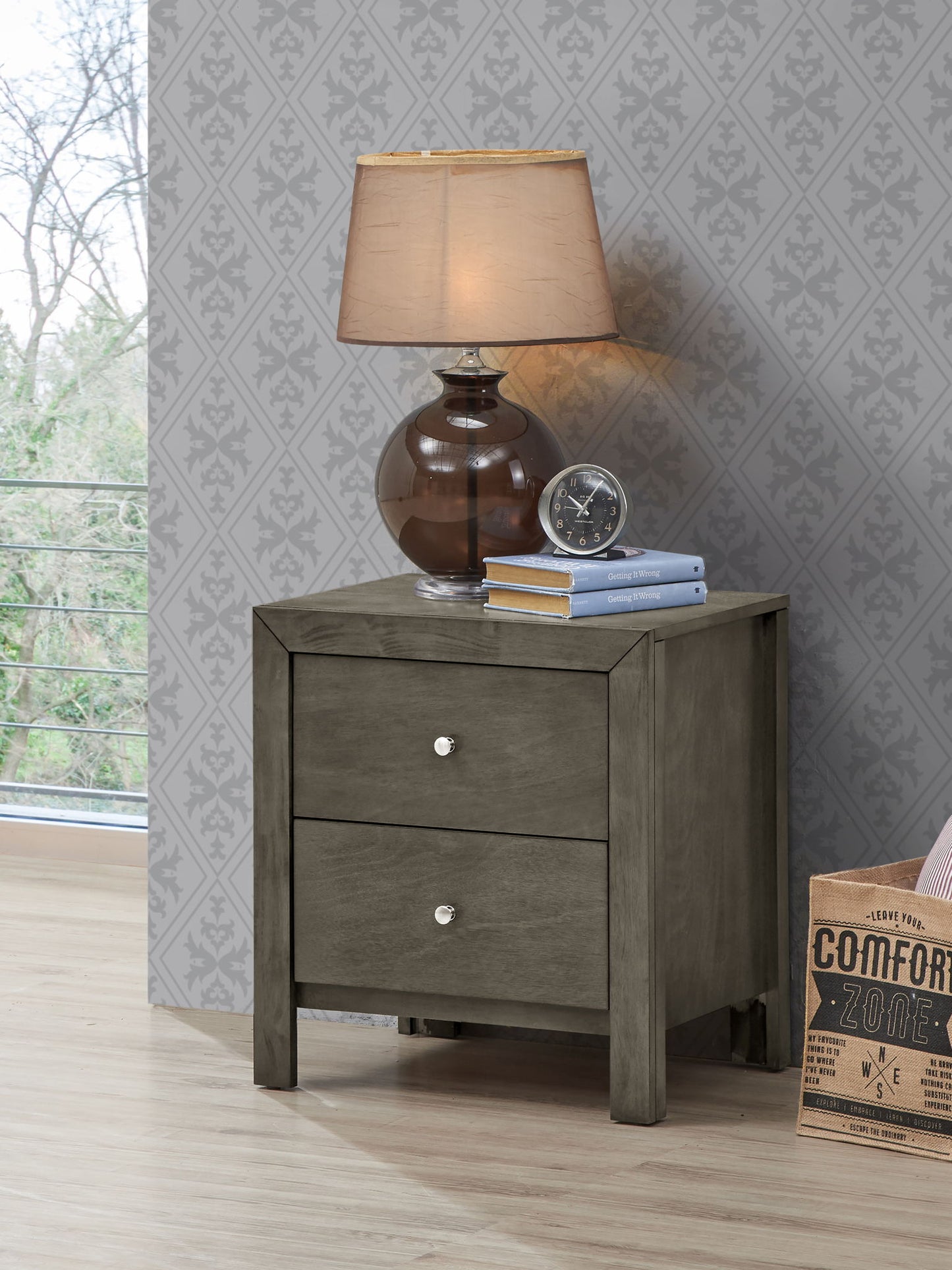 A Charming Nightstand With Drawers displayed with a lamp.