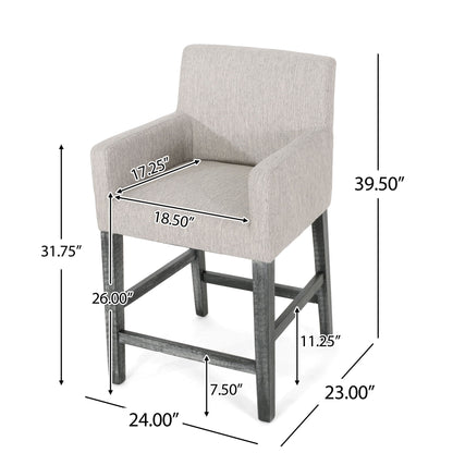 The Charmed Upholstered Counter Stool features a grey fabric, low back, round arms, and H frame base. Dimensions: height 39.5", seat height 26", width 24", depth 23", seat depth 18.5", seat width 17.25", arm height 31.75".
