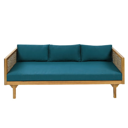 The Claremont 3 Seater Daybed features a teak acacia wood frame with woven rattan sides and teal blue water-resistant cushions—three for the back and one long seat cushion—displayed against a white background.