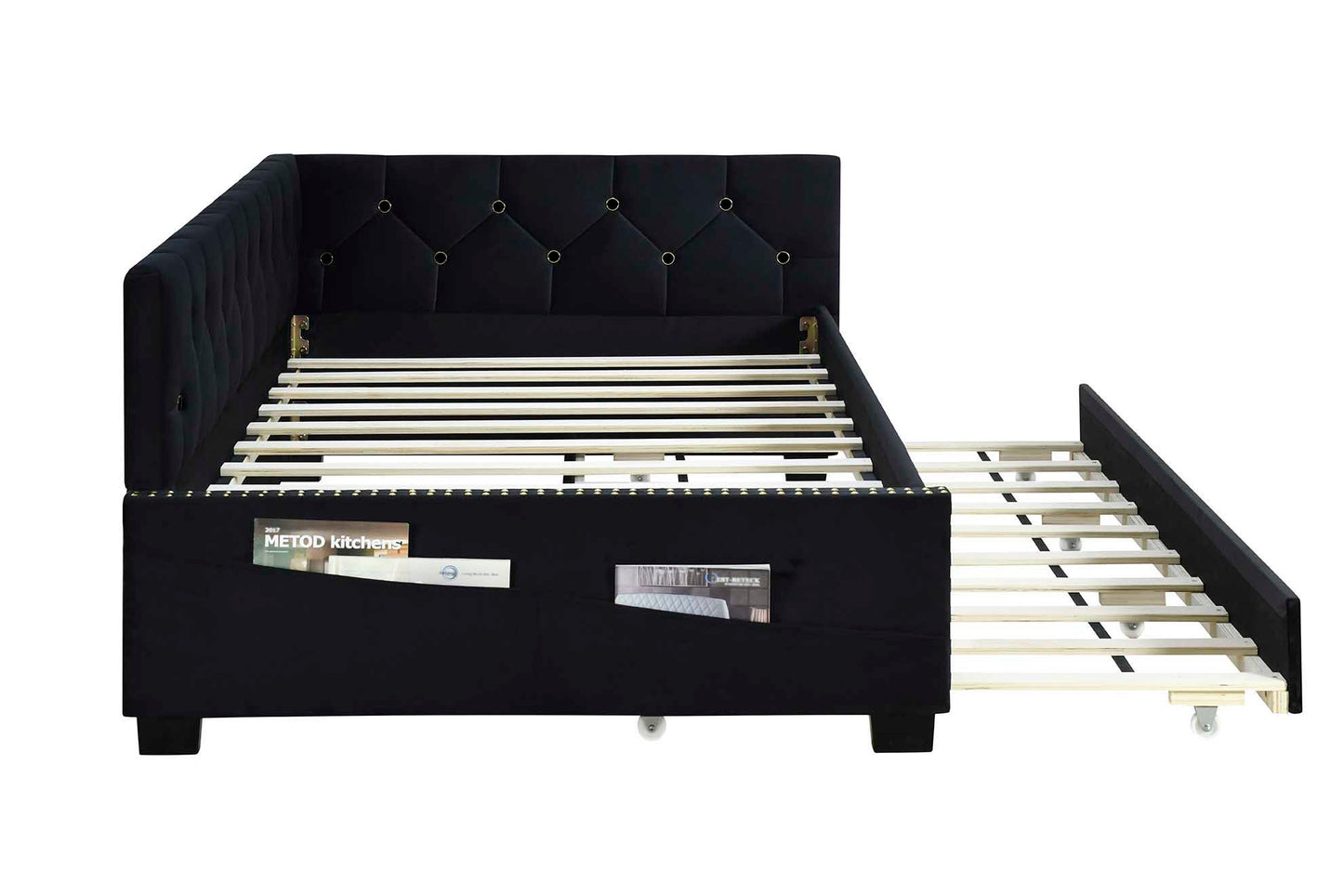 The Upholstered Twin Size Daybed Bed Frame features black velvet fabric, a studding design, a button-tufted backrest, wooden slats, two magazine side pockets, and a pull-out trundle on wheels. No box spring required.