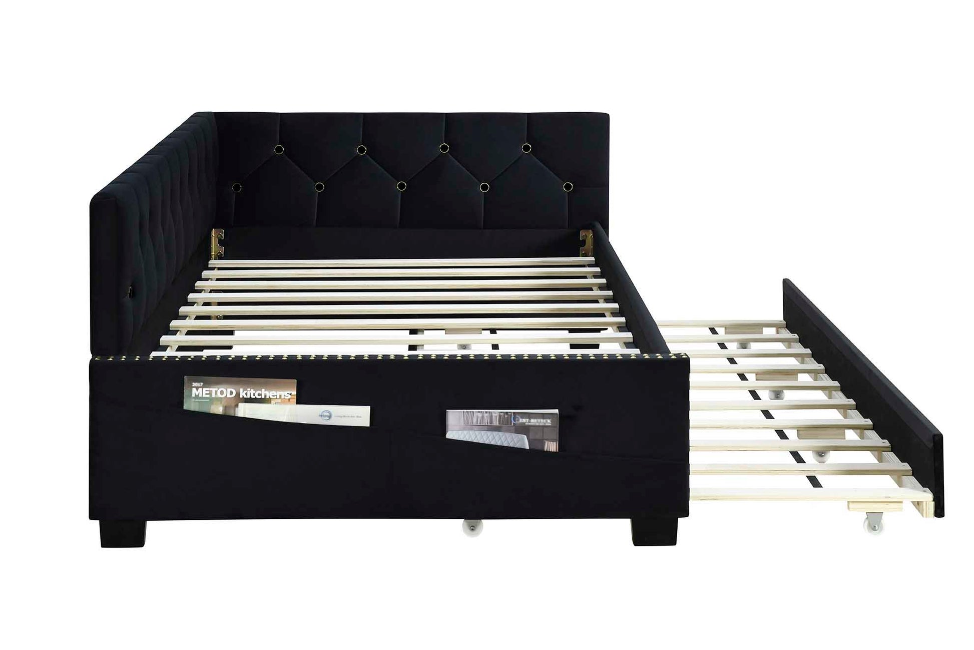 The Upholstered Twin Size Daybed Bed Frame features black velvet fabric, a studding design, a button-tufted backrest, wooden slats, two magazine side pockets, and a pull-out trundle on wheels. No box spring required.