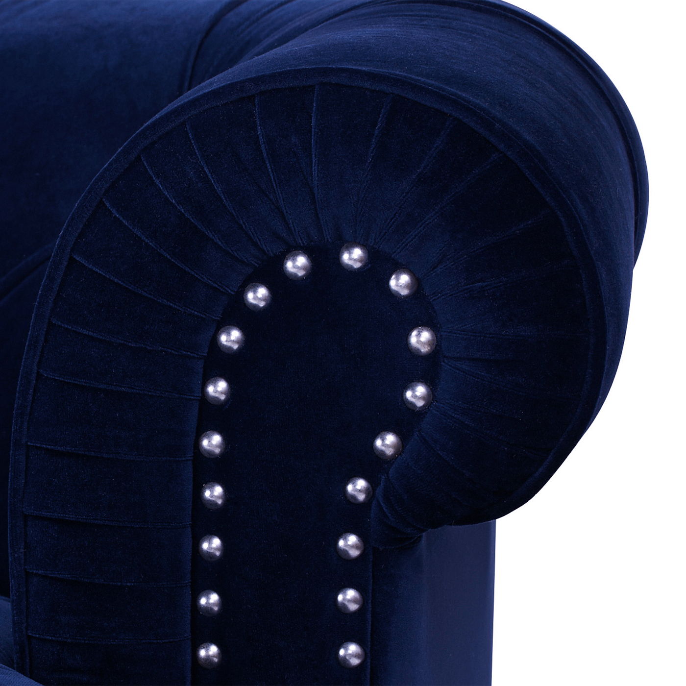Close-up of the La Rosa - Victorian Chesterfield Tufted Sofa’s dark blue velvet armrest with silver nailhead trim and pleated detail, showcasing its plush and luxurious upholstery.