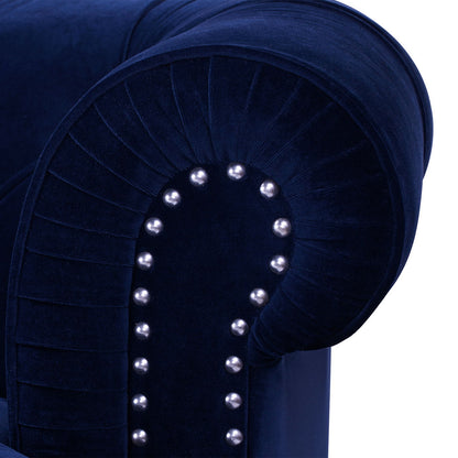Close-up of the La Rosa - Victorian Chesterfield Tufted Sofa’s dark blue velvet armrest with silver nailhead trim and pleated detail, showcasing its plush and luxurious upholstery.