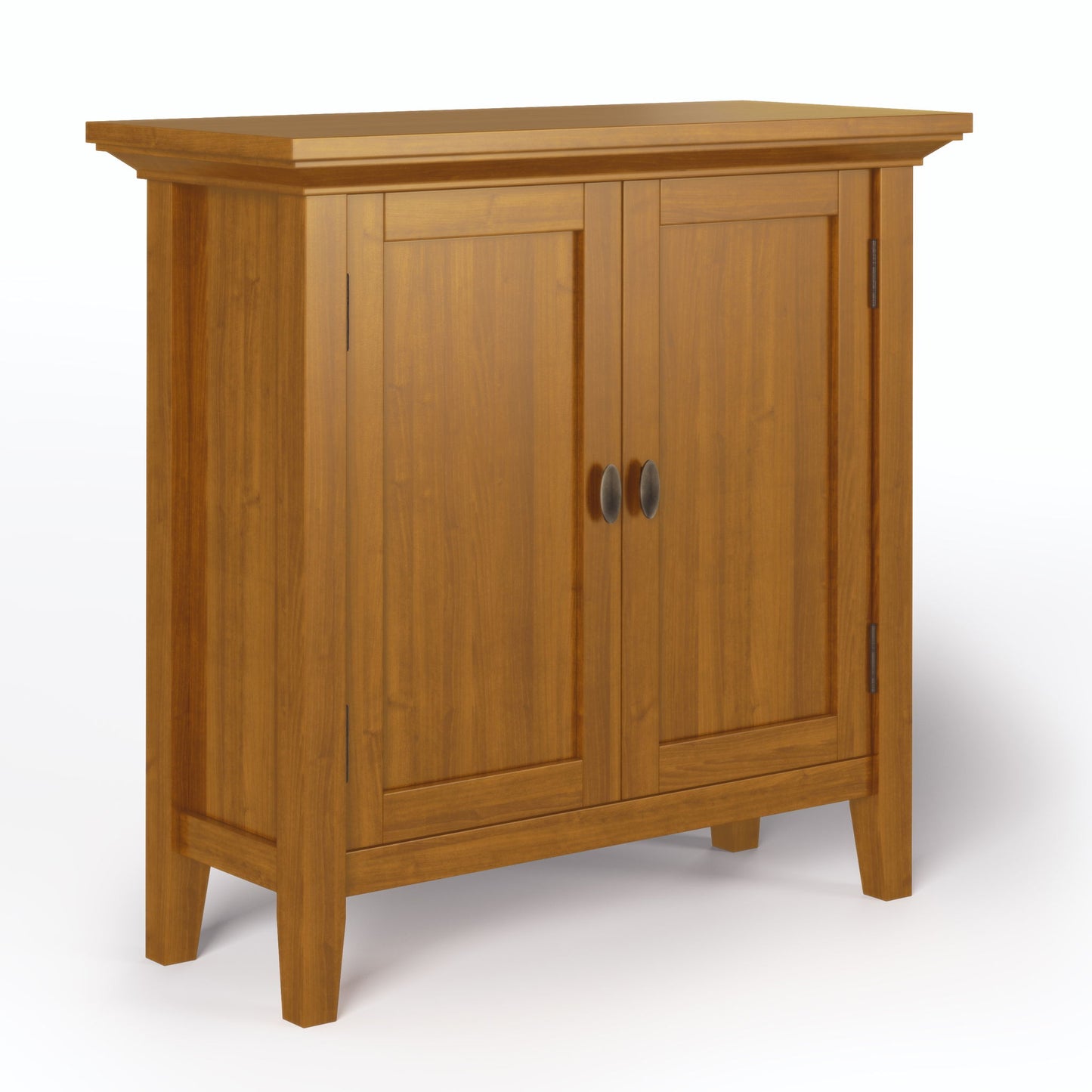The Redmond Handcrafted Low Storage Cabinet features a natural wood finish, two paneled doors with round metal handles, and four straight legs, shown against a white background.
