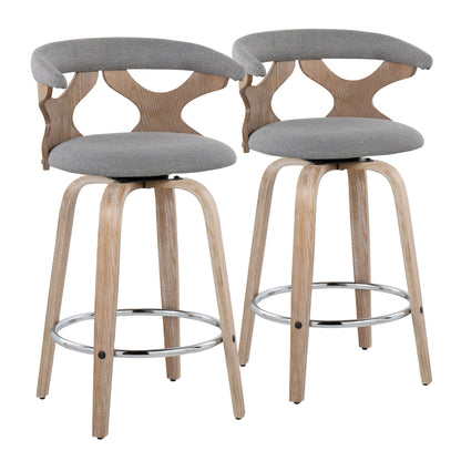 The Gardenia set includes two mid-century modern fixed height counter stools with swivel, light wood legs, chrome circular footrests, curved open-backrests with geometric cutouts, and gray upholstered seats and backs.