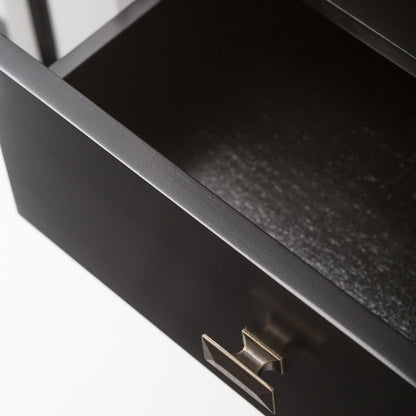 A close-up view of an open, empty black drawer with a metallic handle from the Artisan Handcrafted Tall TV Media Stand, shown against a plain white background.