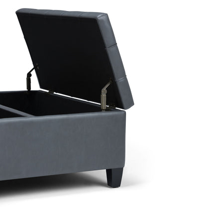 The Harrison Upholstered Coffee Table Storage Ottoman in gray is shown with its lid open, revealing interior storage space and sturdy metal hinges, all set against a white background.