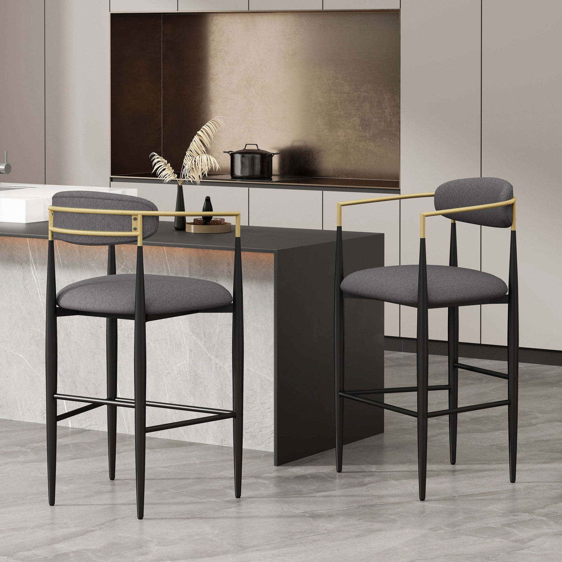 Two Counter Height Upholstered Barstools (Set of 2) with black frames, gold accents, and gray cushions sit at a marble kitchen island in a modern kitchen featuring neutral cabinetry and minimalist design.