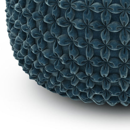 Close-up of Renee - Handcrafted Round Pouf in dark blue, showing its textured surface with a repeating pattern of raised, petal-like shapes on a white background.