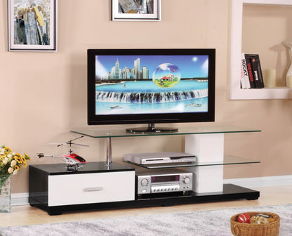 The Ivana TV Stand in White/Black features a flat-screen TV, glass shelves for electronics, a drawer, a toy helicopter on the left, a basket of toys on the floor, and framed art on the beige wall.