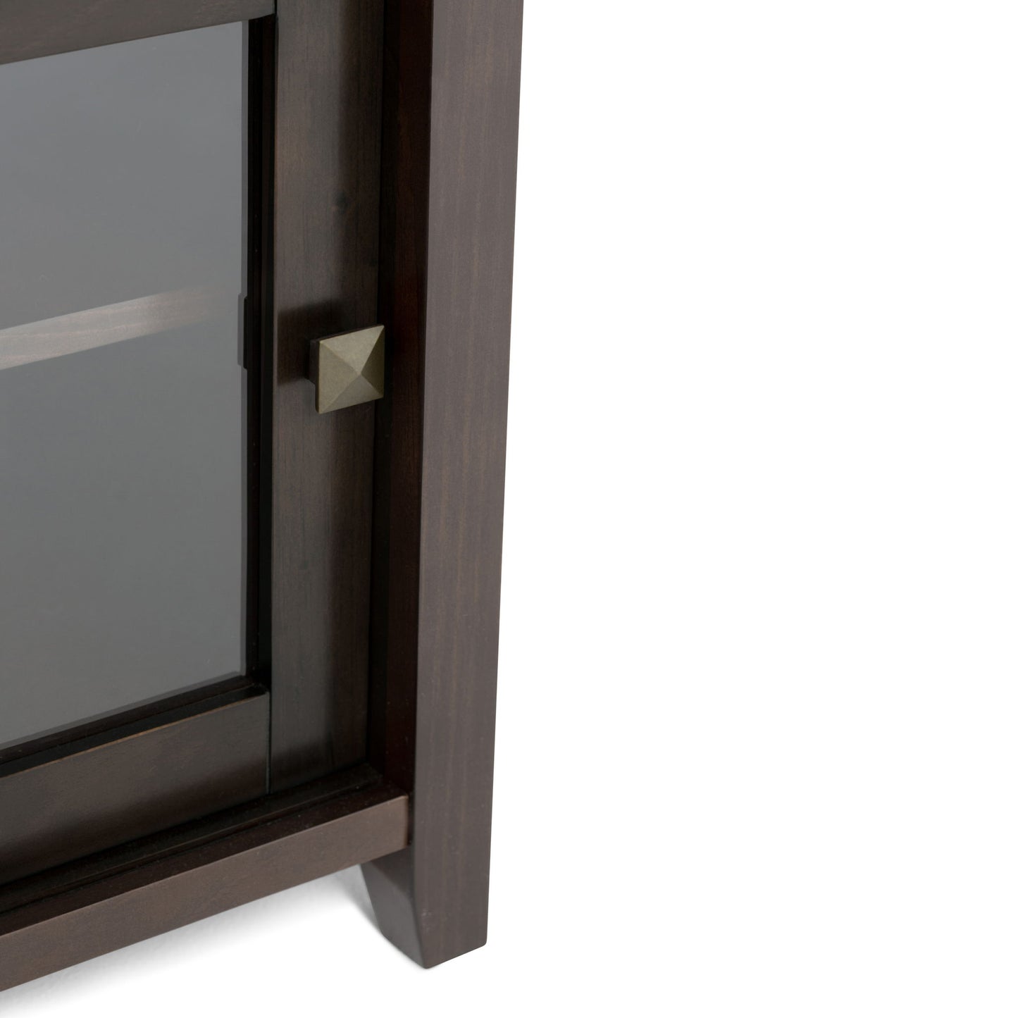 Close-up of the Cosmopolitan - Handcrafted TV Media Stand, featuring a dark wooden corner, glass door with a square brass knob, and an interior shelf.