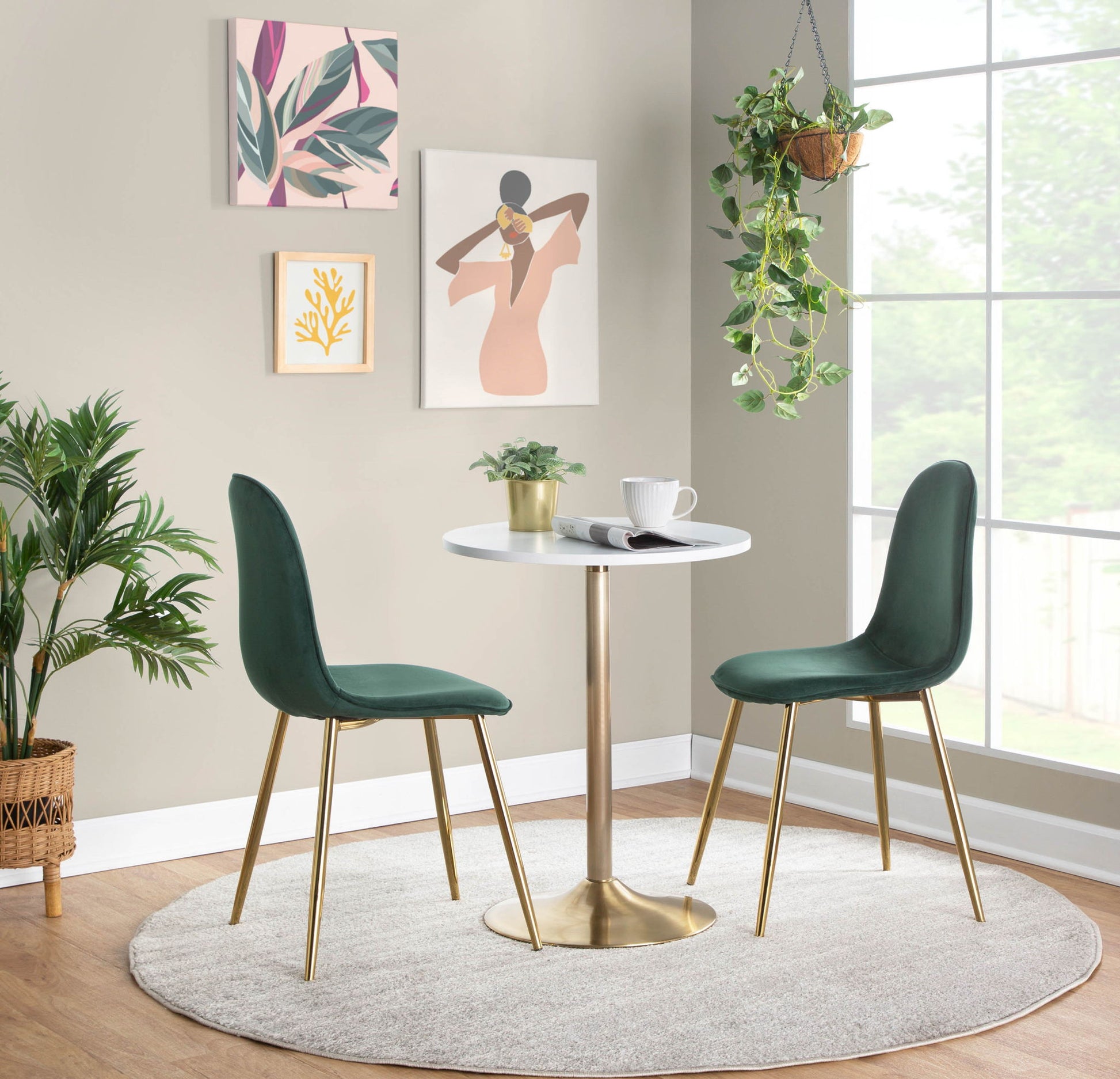 A modern dining nook featuring two green velvet chairs and the Pebble Contemporary & Glam Adjustable Dining / Bar Table on a light gray rug, surrounded by plants and abstract art near a sunlit window.
