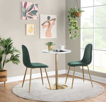 A modern dining nook featuring two green velvet chairs and the Pebble Contemporary & Glam Adjustable Dining / Bar Table on a light gray rug, surrounded by plants and abstract art near a sunlit window.