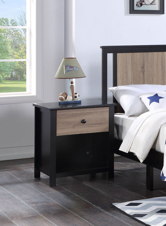 The Connelly Nightstand, in modern black and wood, sits beside a bed with white star-patterned bedding. Topped with a lamp, toy car, and two small balls, it's placed next to a large window overlooking greenery.